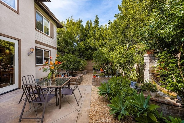 view of patio featuring outdoor dining area and fence