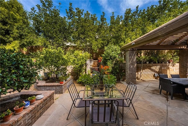 view of patio featuring a fenced backyard, a pergola, and outdoor dining space