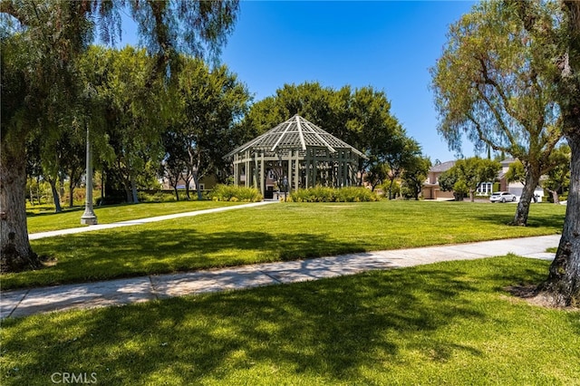 view of home's community with a lawn and a gazebo