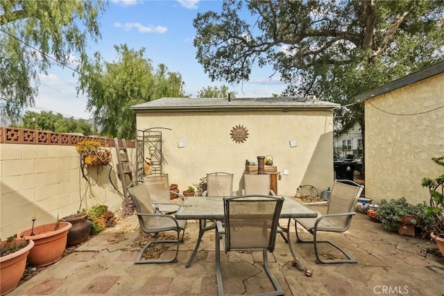 view of patio / terrace featuring outdoor dining area and fence