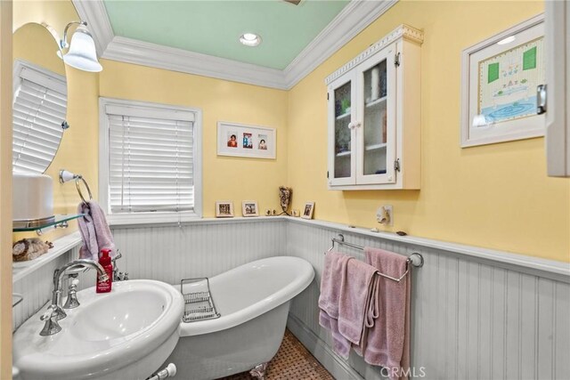 12626 Cometa Ave, San Fernando, CA 91340 - bathroom with a sink, ornamental molding, a wainscoted wall, and a soaking tub