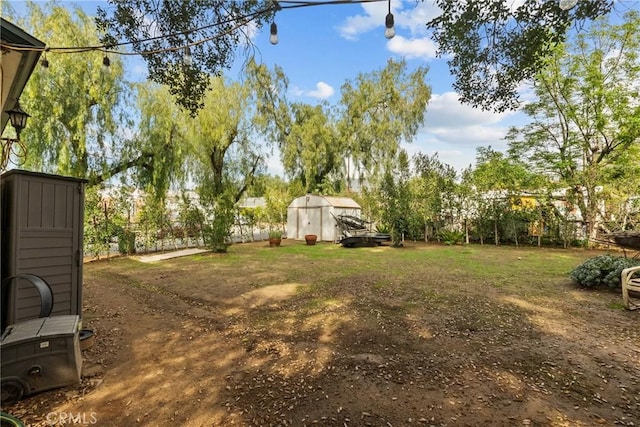 view of yard with an outbuilding and a shed