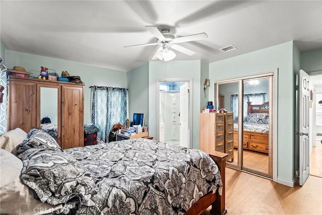 bedroom featuring light wood-style floors, ceiling fan, and visible vents