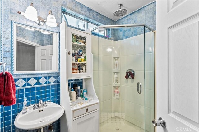 12626 Cometa Ave, San Fernando, CA 91340 - bathroom featuring a sink, a shower stall, and tile walls