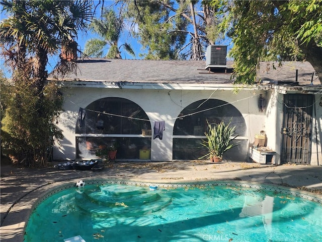 view of pool with central AC and a patio