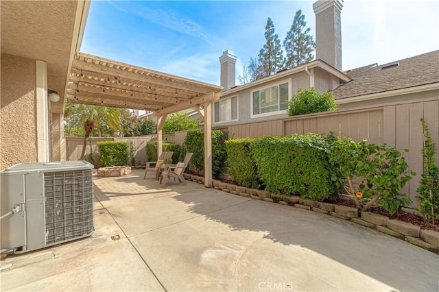 view of patio with central AC unit, a pergola, and a fenced backyard