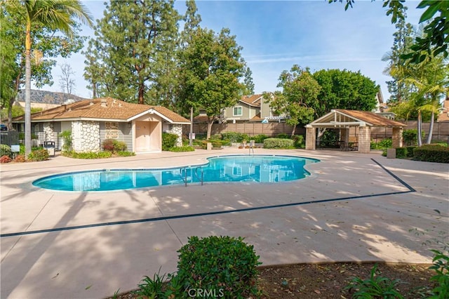 view of swimming pool with a gazebo, fence, a patio, and a fenced in pool