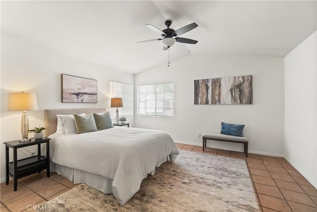 tiled bedroom featuring vaulted ceiling, baseboards, and a ceiling fan