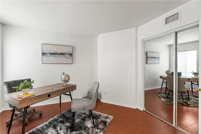 office featuring wood finished floors, baseboards, and visible vents