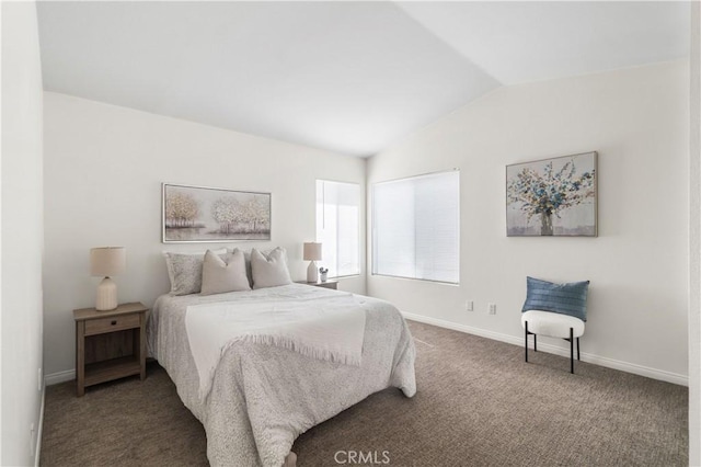 carpeted bedroom with baseboards and lofted ceiling