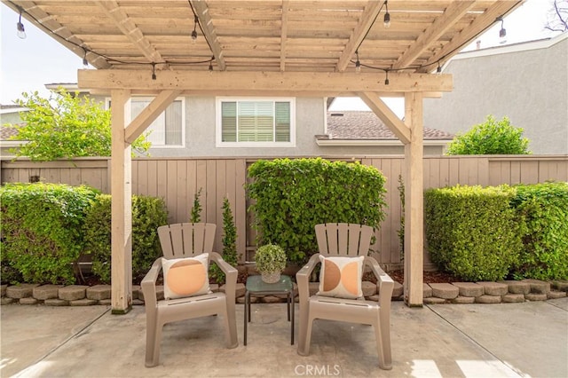 view of patio / terrace with a pergola and fence