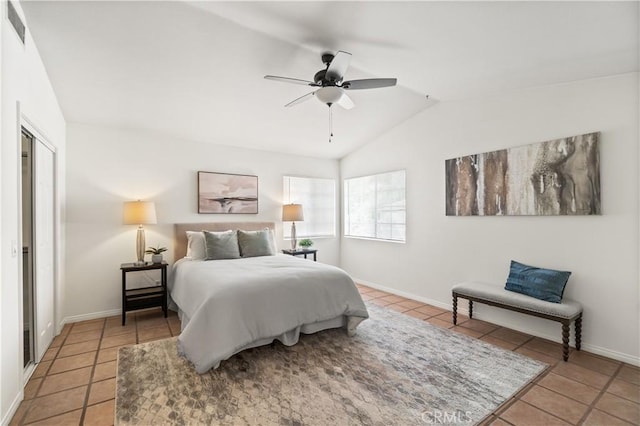 bedroom featuring visible vents, lofted ceiling, ceiling fan, light tile patterned flooring, and baseboards