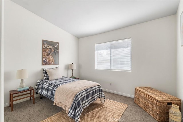 bedroom with vaulted ceiling, baseboards, and carpet