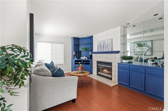 living room with wood finished floors and a fireplace