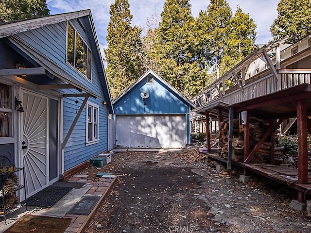 view of yard with an outbuilding, a deck, and a garage