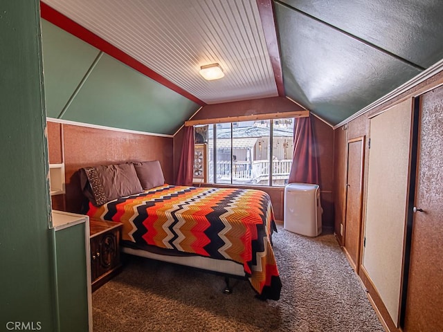 bedroom featuring dark carpet and vaulted ceiling