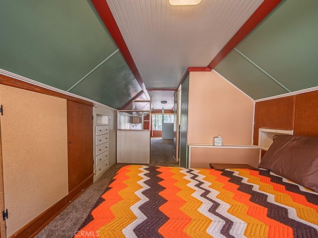 unfurnished bedroom with vaulted ceiling and carpet floors