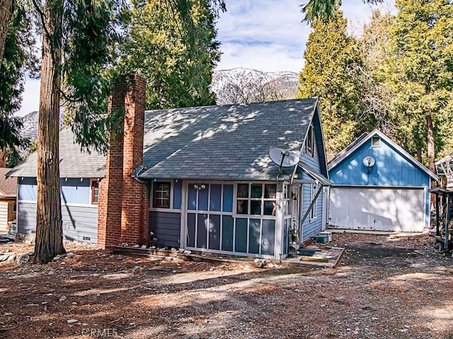 rear view of property with a mountain view