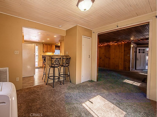 interior space with wooden ceiling and carpet flooring