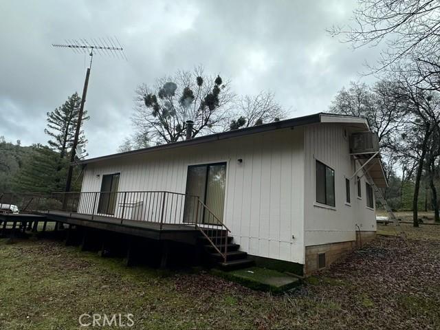 rear view of property featuring a wooden deck