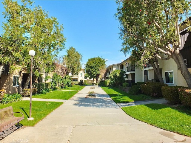 view of home's community featuring a lawn and a residential view