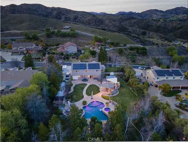 aerial view at dusk featuring a mountain view