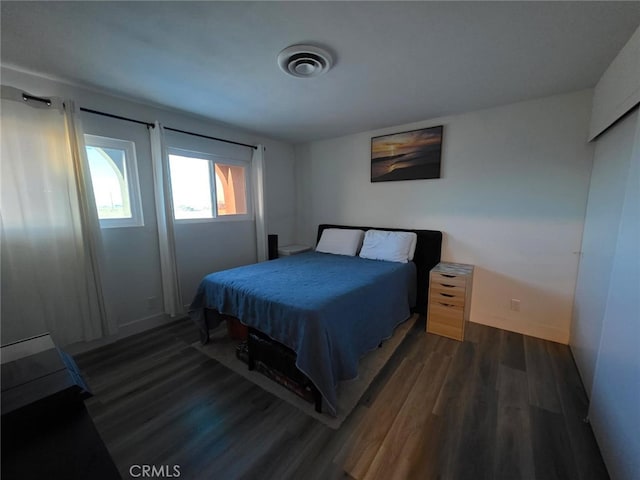 bedroom featuring visible vents and dark wood finished floors