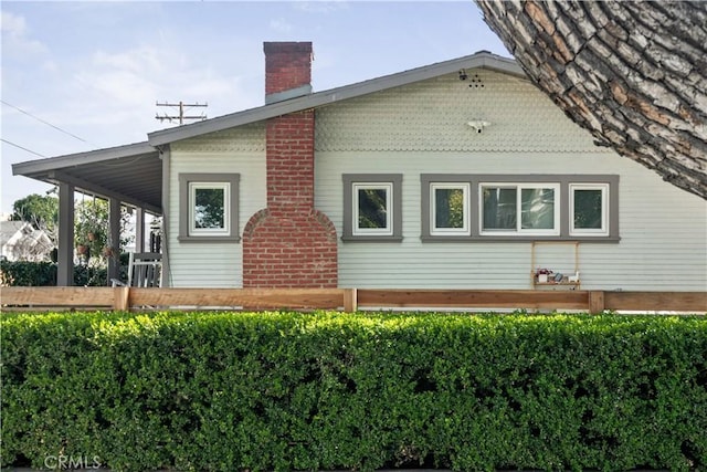 view of side of home with a chimney