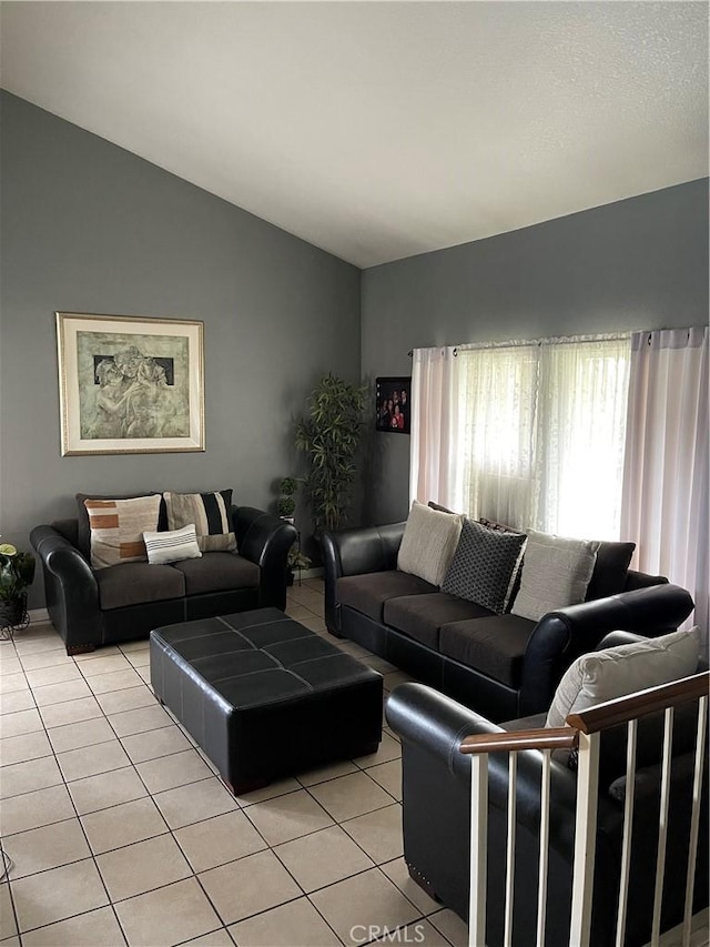 tiled living room featuring vaulted ceiling