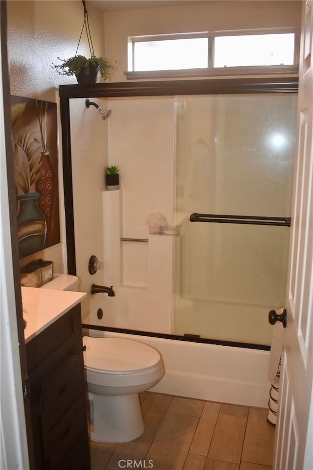 1041 E Riverside Dr, Ontario, CA 91761 - bathroom with vanity, toilet, and bath / shower combo with glass door