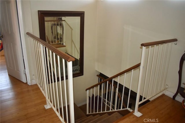 1041 E Riverside Dr, Ontario, CA 91761 - staircase featuring wood finished floors and baseboards