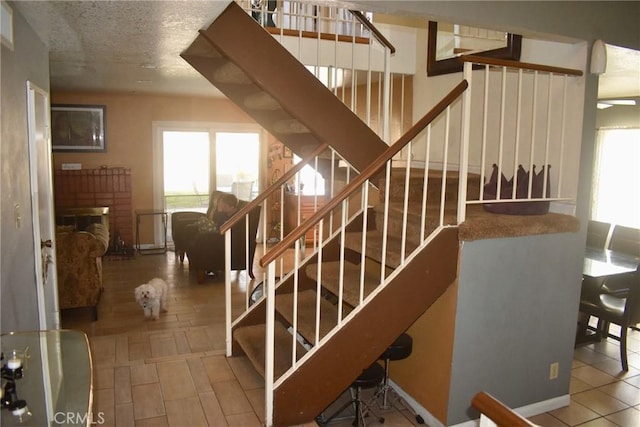 1041 E Riverside Dr, Ontario, CA 91761 - stairs with a textured ceiling and wood finished floors