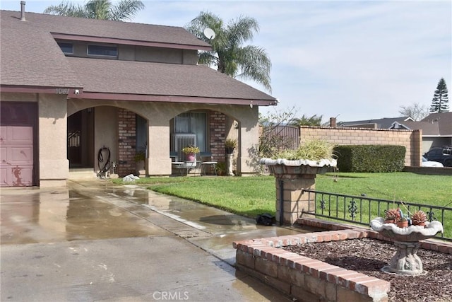 1041 E Riverside Dr, Ontario, CA 91761 - view of front of house featuring brick siding, a front yard, fence, and stucco siding