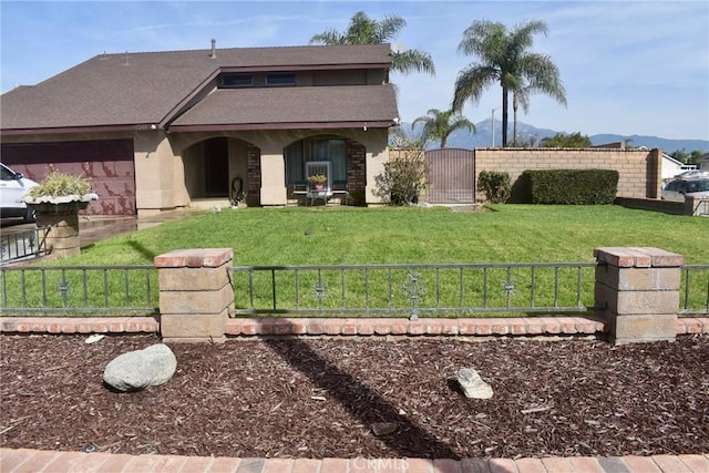 1041 E Riverside Dr, Ontario, CA 91761 - view of front of home with a gate, fence, a mountain view, and a front yard