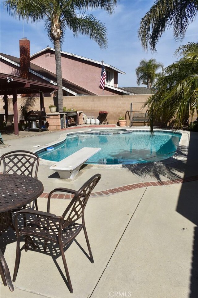 1041 E Riverside Dr, Ontario, CA 91761 - view of swimming pool with a fenced in pool, a patio area, fence, and a diving board