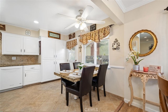 dining room featuring ornamental molding, light tile patterned floors, baseboards, and a ceiling fan