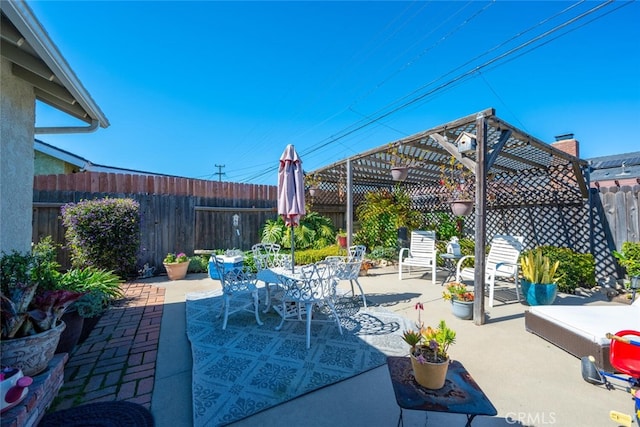 view of patio with a fenced backyard, outdoor dining area, and a pergola