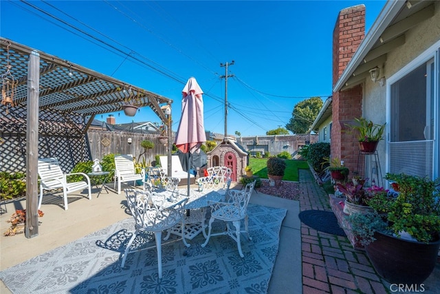 view of patio / terrace with outdoor dining space, a fenced backyard, and a pergola