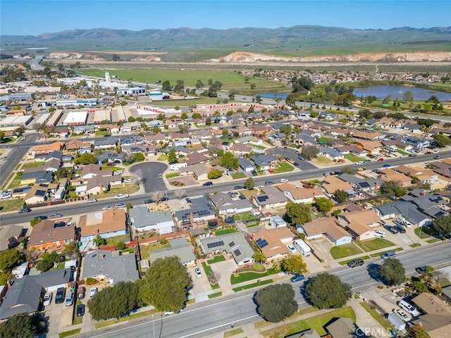 drone / aerial view with a residential view and a water and mountain view