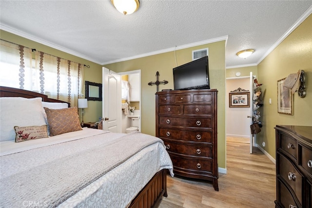 bedroom featuring a textured ceiling, visible vents, baseboards, ornamental molding, and light wood-type flooring