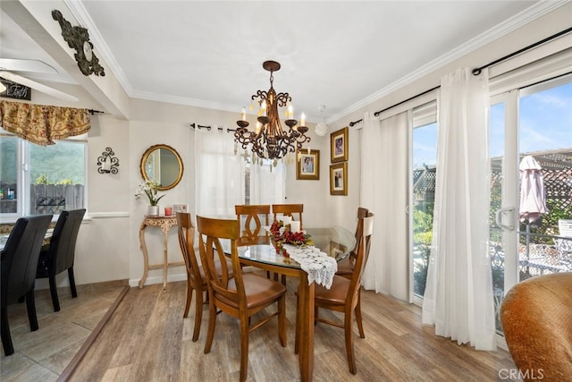 dining space with crown molding, plenty of natural light, and wood finished floors