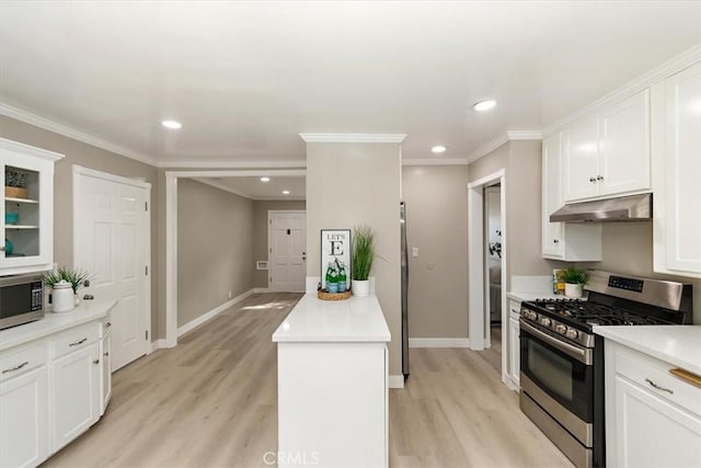 kitchen with white cabinets, appliances with stainless steel finishes, extractor fan, and ornamental molding