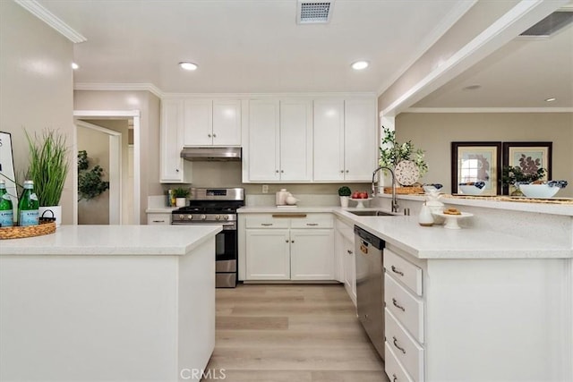 kitchen featuring visible vents, a peninsula, stainless steel appliances, under cabinet range hood, and a sink