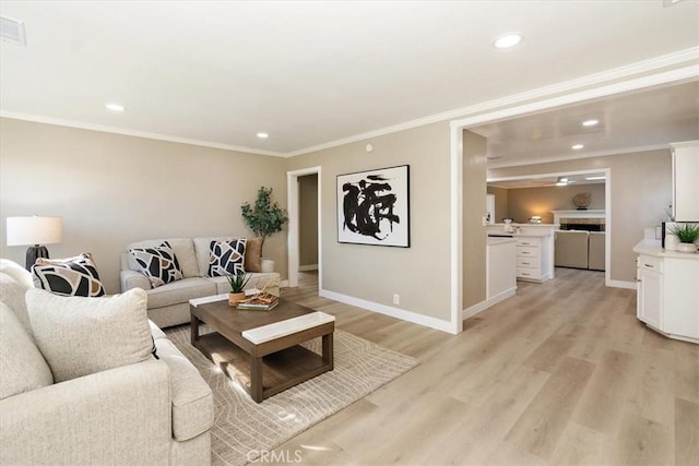 living area featuring baseboards, ornamental molding, recessed lighting, and light wood-style floors