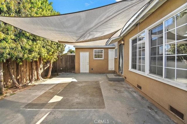 view of patio featuring fence and visible vents