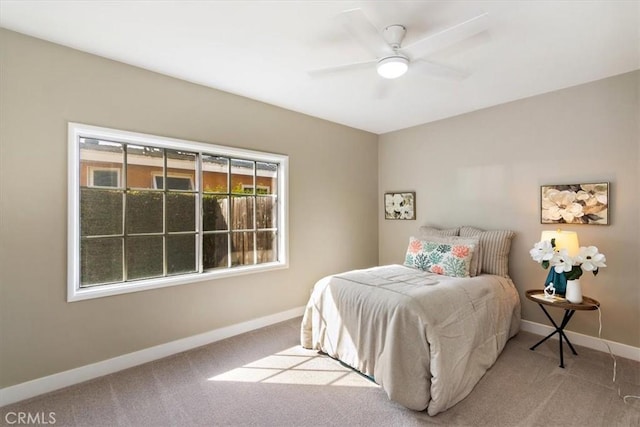 carpeted bedroom featuring a ceiling fan and baseboards