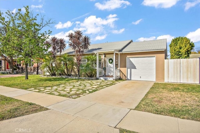 ranch-style house featuring driveway, an attached garage, fence, a front lawn, and stucco siding