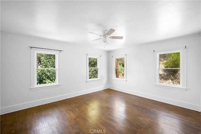 unfurnished room featuring ceiling fan, dark wood-style flooring, and baseboards