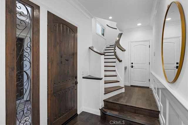 foyer with crown molding and dark hardwood / wood-style floors