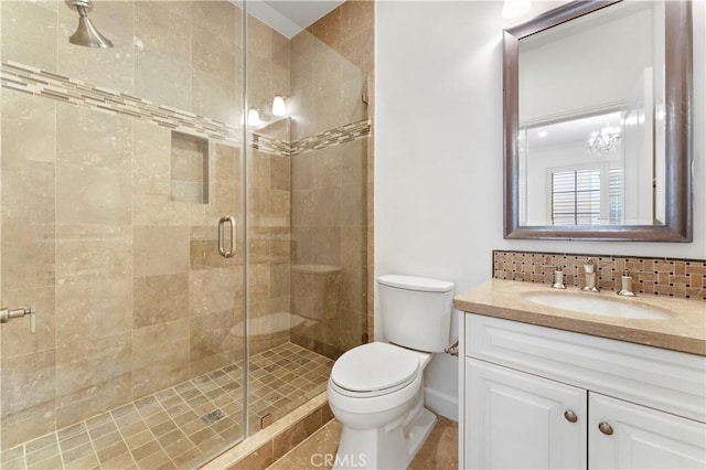 full bath featuring toilet, a shower stall, decorative backsplash, and vanity